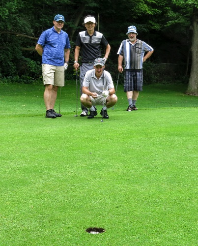 The Fore Aces take teamwork seriously as they consider the next putt!